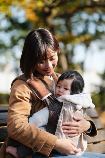 istock Mother embracing baby and talking to her 1080877710