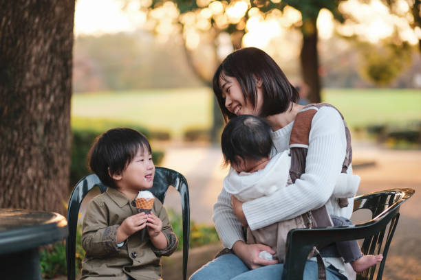 istock Child eating ice cream with mother 1080888964