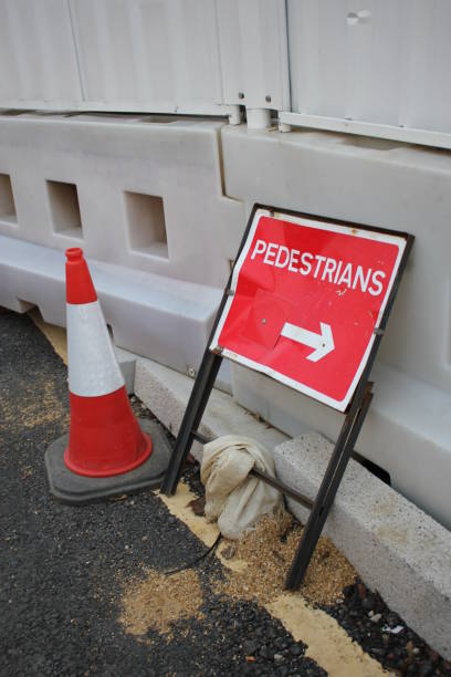 istock Pedestrian Dented Metal Roadwork Sign and Traffic Cone 1080892082