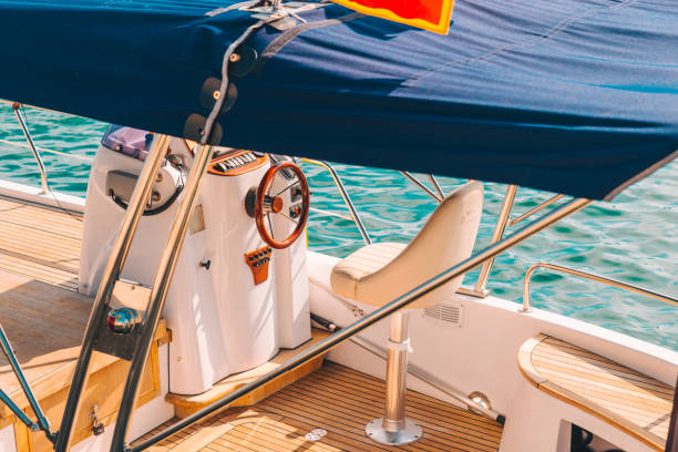 istock boat deck with steering wheel close up 1080902954