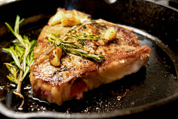 istock Juicy T-bone Beef Steak in a Cast Iron Skillet 1080903028