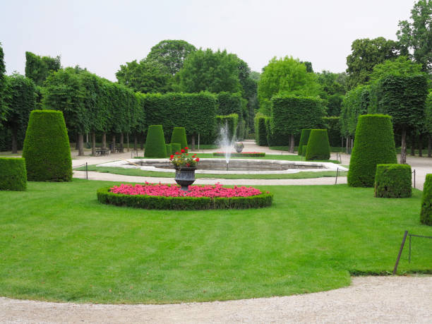 istock Abstract ideal flower beds and shorn trees in well-kept park 1080909708