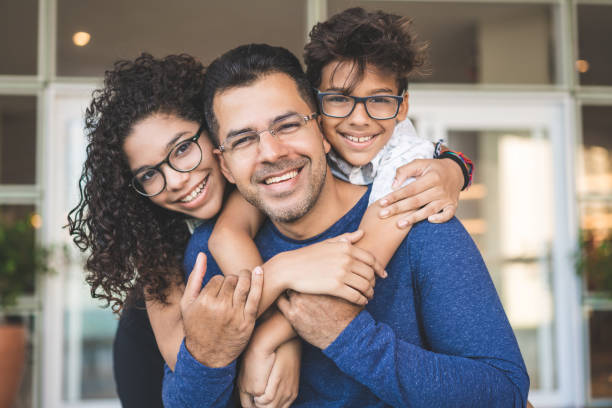 Portrait of happy family Son, Daughter, Family, Embracing, Single Father latin american and hispanic culture photos stock pictures, royalty-free photos & images