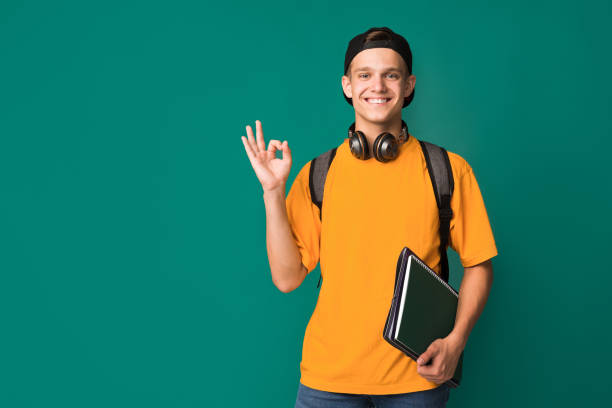 istock Student guy showing ok sign over turquoise background 1080915244