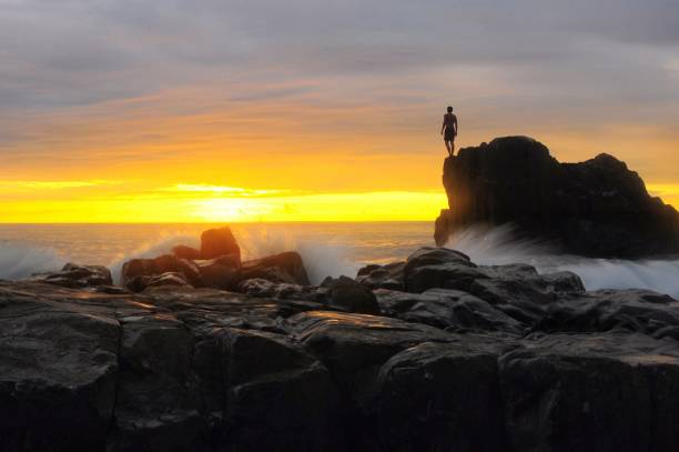 istock Rocks In Sea Against Sky During Sunset 1080923350