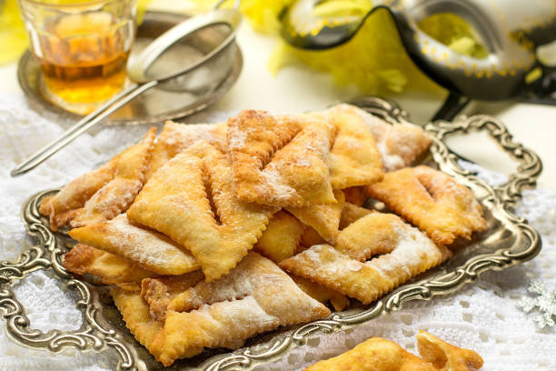 Traditional sweet crisp beignet Angel wings with powdered sugar and rum Traditional sweet crisp beignet Angel wings with icing sugar and rum beignet stock pictures, royalty-free photos & images