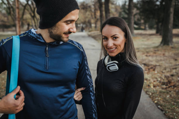 istock Young couple exercising together in the park 1080925578