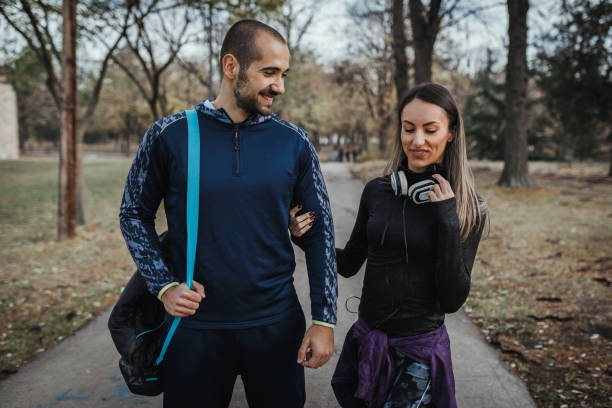 istock Young couple exercising together in the park 1080926056
