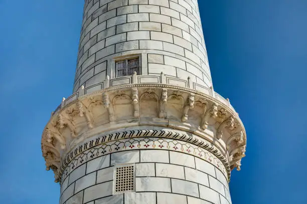 Photo of Taj Mahal in Agra, India – Close-up of Balcony, Door and Inlay of Precious Stones on One of Four Cylindrical White Granite Minarets under a Clear Blue Sky