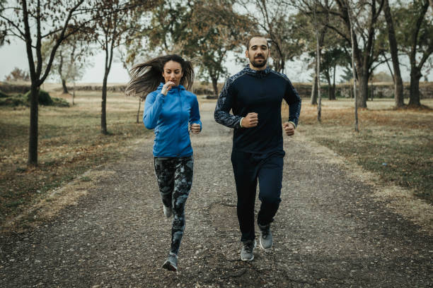 istock Two people running and exercising in the public park 1080930008