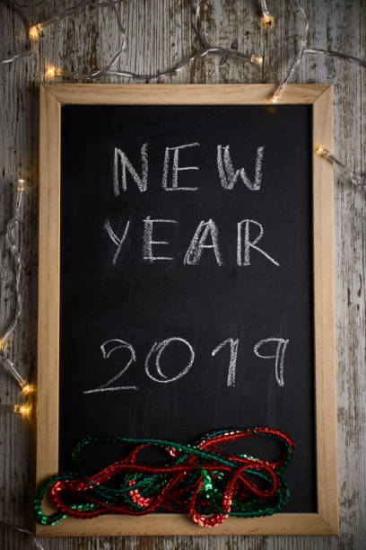 istock Black chalkboard with the written words NEW YEAR 2019 1080939374
