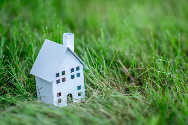 istock Model house sitting in grass 1080945688