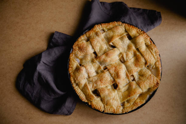 istock Apple pie with lattice decoration on beige background with a textile napkin 1080950414