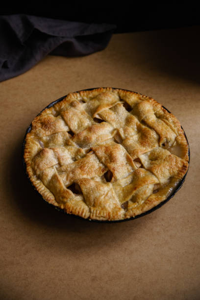 istock Apple pie with lattice decoration on beige background with a textile napkin 1080950418
