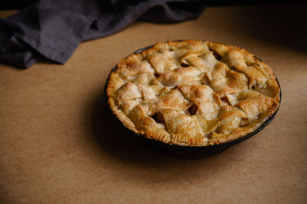istock Apple pie with lattice decoration on beige background with a textile napkin 1080950454