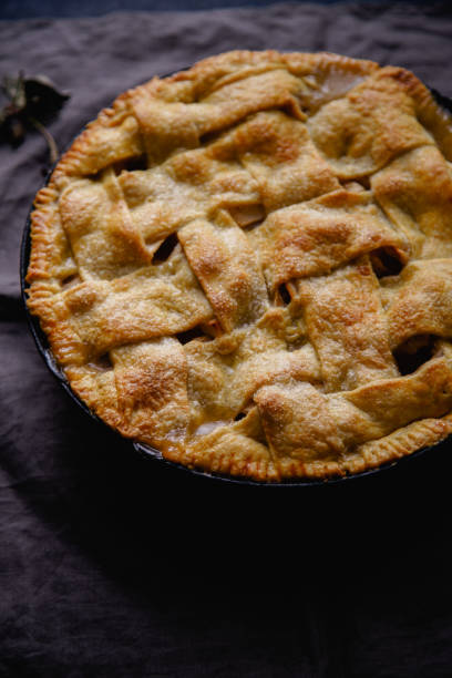 istock Apple pie with lattice decoration on dark background 1080950462