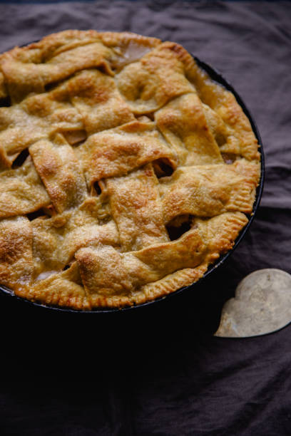 istock Apple pie with lattice decoration on dark background 1080950478