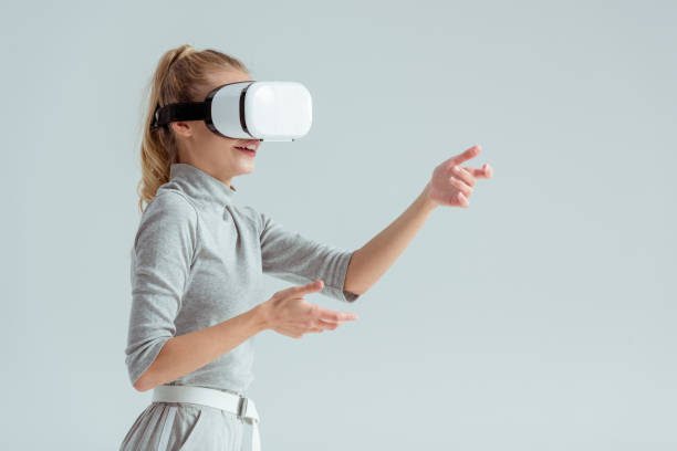 istock surprised woman gesturing while having virtual reality experience isolated on grey 1080951094