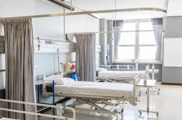 istock Empty hospital bed on ward with open curtain 1080953188