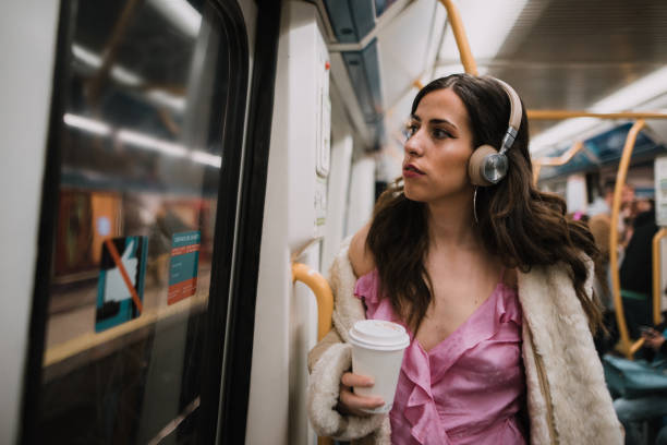 istock Young woman with headphones inside subway train 1080958792