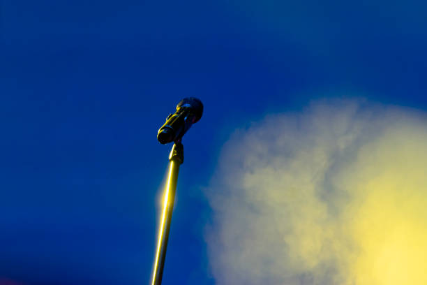istock Microphone in nighttime outdoor concert, artificial lighting. 1080958978