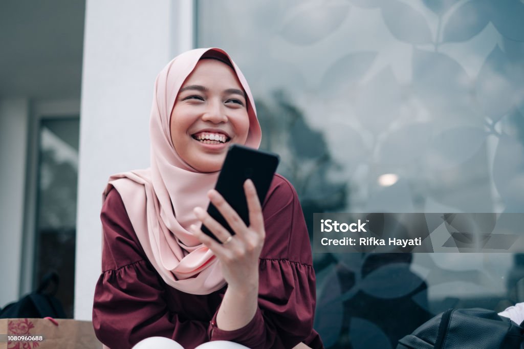 Young Asian Muslim Women Playing Smartphone Lifestyle technology Teenager Stock Photo