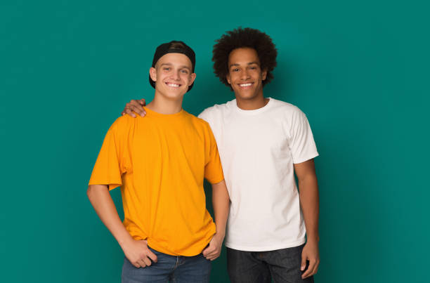 istock Two best friends hugging and looking at camera over background 1080967248