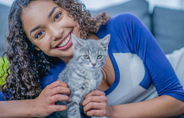 istock Young woman playing with a kitten 1080968480