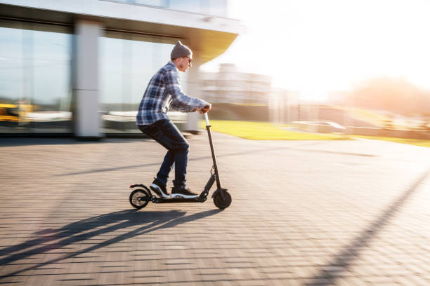 istock Young man on electric scooter on street 1080969722