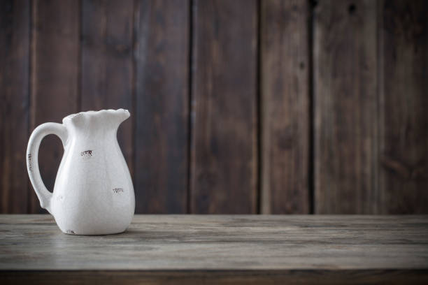 istock white jug on wooden background 1080977892