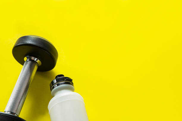 istock Gym background with dumbbell and sport bottle 1080981376