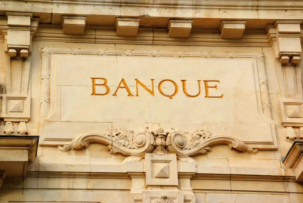 Inscription on the pediment of a stone building indicating a bank.