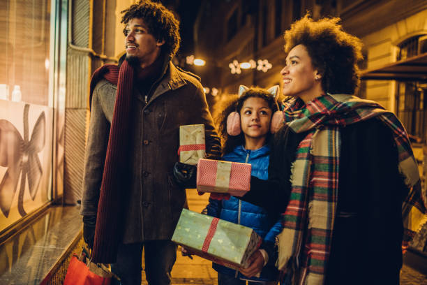 istock Young family looking for Christmas presents 1080990656