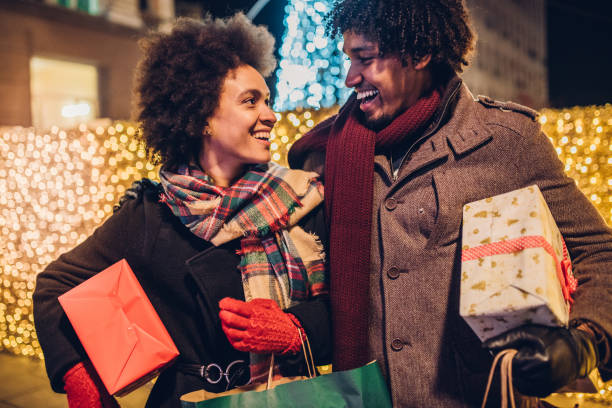 istock Young couple carrying Christmas presents 1080992274