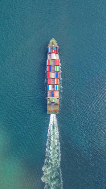 istock Container ship in export and import business and logistics. Shipping cargo to harbor by crane. Water transport International. Aerial view and top view. 1080998054