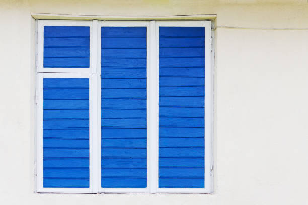 istock The old window is painted blue. The wire is on the wall. 1080998856