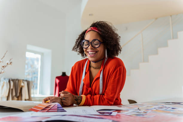 istock Laughing contented woman sorting out color palette 1080999388