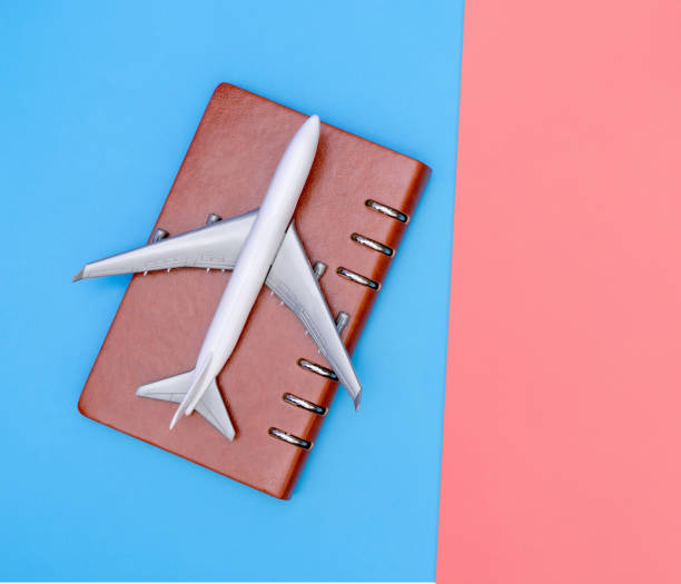 istock white toy plane on blue and pink background 1080999488