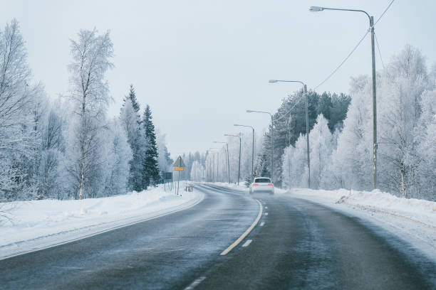 istock Car at a road in a snowy winter Lapland 1081003830