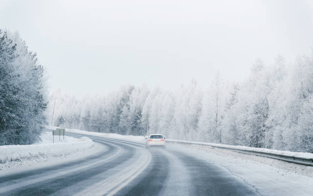 istock Car in a road at a snowy winter Lapland 1081003842