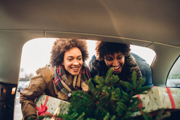 istock Smiling people with Christmas tree and gift boxes 1081005028