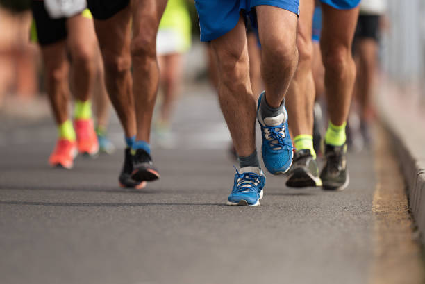 istock Marathon runners running on city road 1081007012
