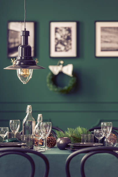 istock Black industrial lamp above dining table with wine glasses, plates and cones 1081012318