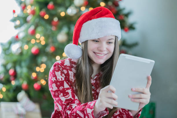 istock Happy young teenager using digital tablet she received as Christmas gift 1081040104