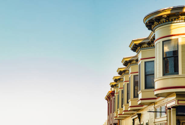 San Francisco residential house architecture with clear blue sky San Francisco residential house architecture with clear blue sky, featuring the upper floors of a row of Victorian houses rotunda photos stock pictures, royalty-free photos & images