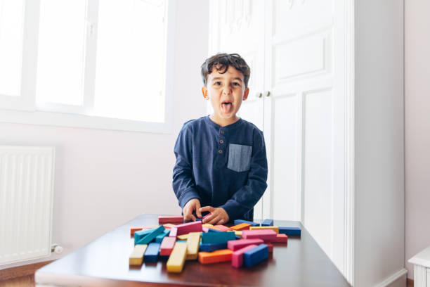 istock Little boy out tongue in indoors 1081049062