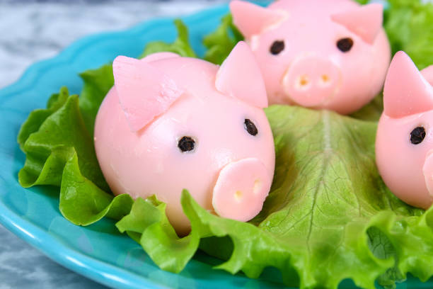 istock Diy pig from eggs. Workshop how to make a pig from a boiled egg painted in broth beets stuffed with stuffing. Appetizer on Christmas or New Year table. Top view. Creative decorative food for kid. 1081052376