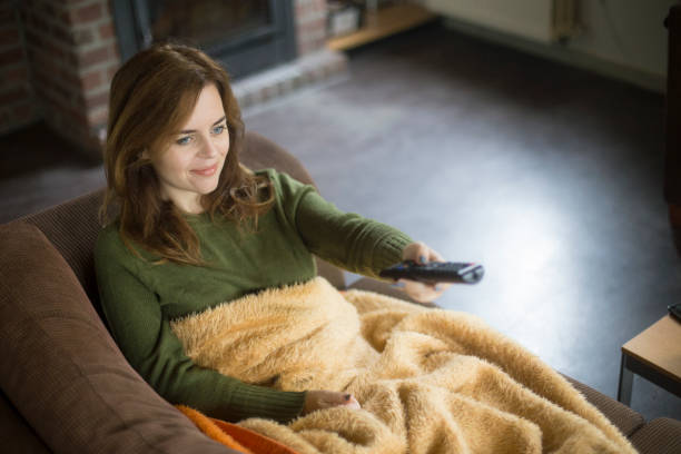 istock Young woman watching television 1081055024