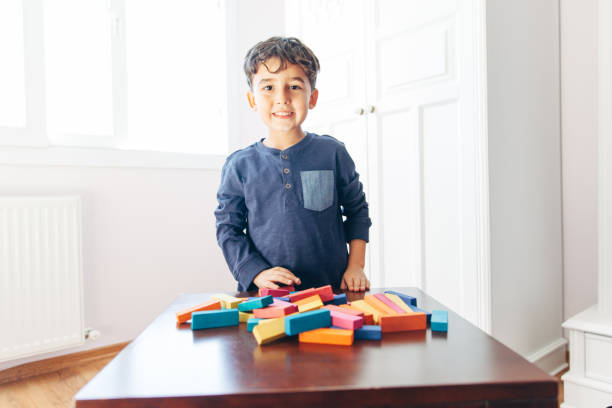 istock Happy boy looking at camera with block game 1081055068