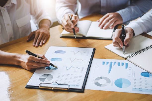 istock Co working conference, Business team colleagues discussing working analysis with financial data and marketing growth report graph in team, Meeting Talking Brainstorming Communication Concept 1081061736